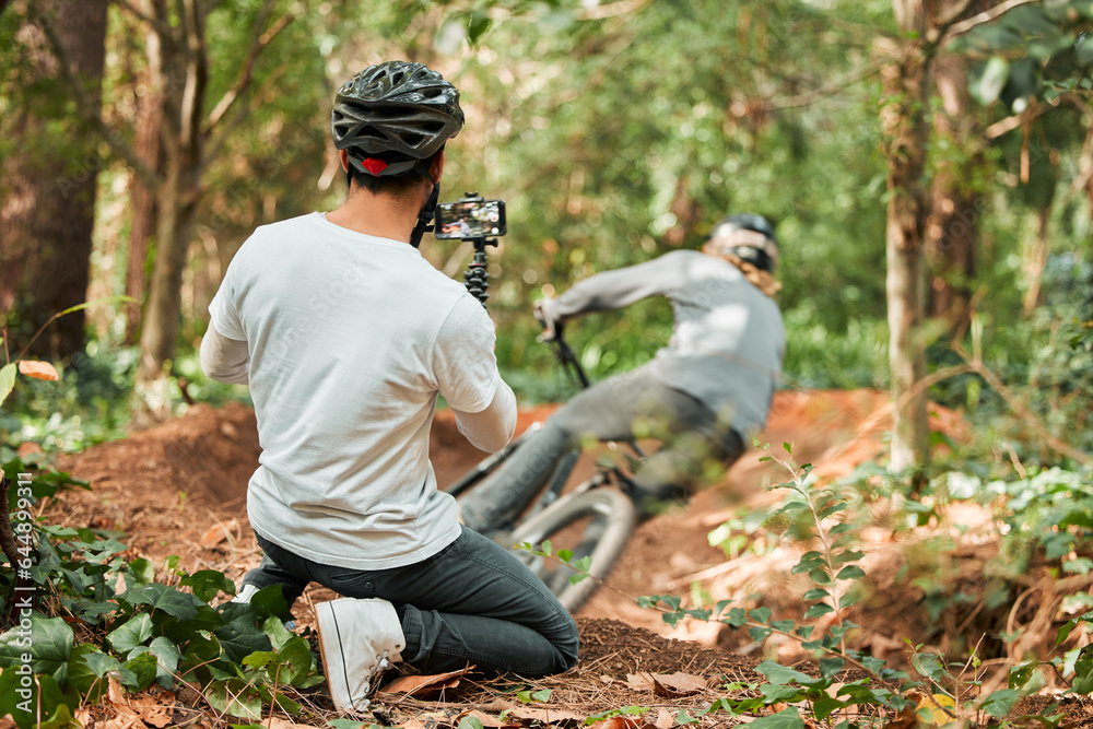 Man, bike and forest with photographer, speed and phone for race, cycling video or post on web blog.