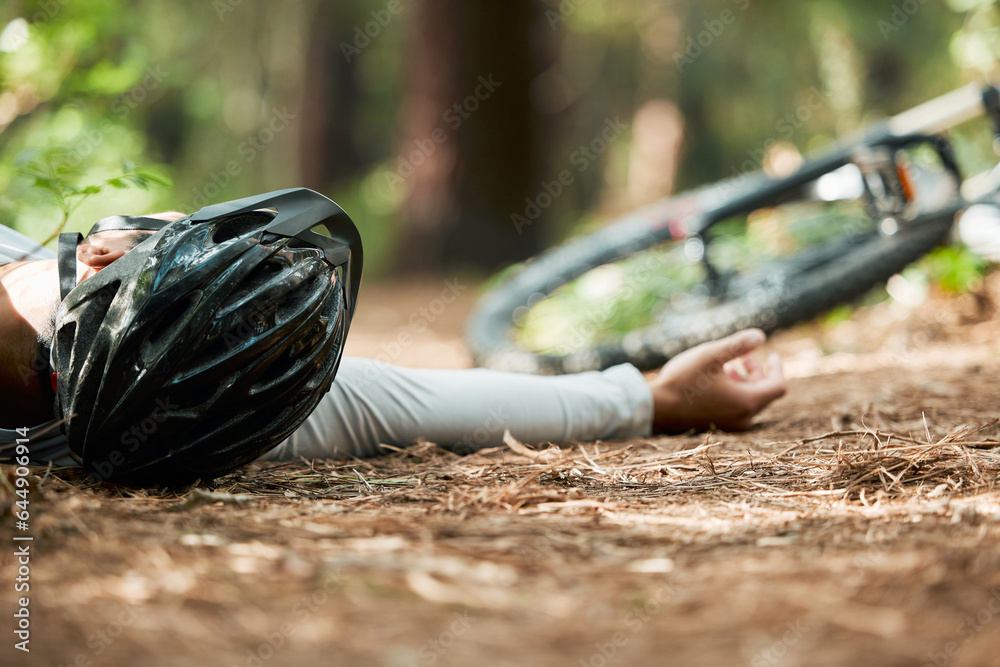 Sports, fitness and cycling accident with a man on the ground while training for a race in the fores