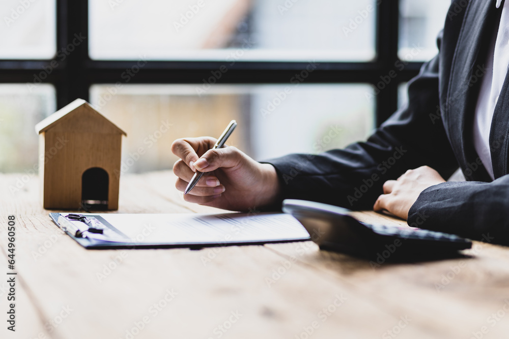 Businesswoman, real estate agent working on paperwork in the office.