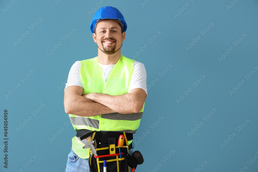 Male builder on blue background