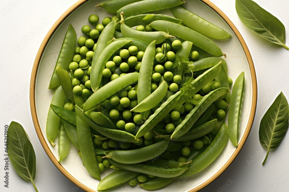 Pea pods and green beans placed on a plate, Top view.