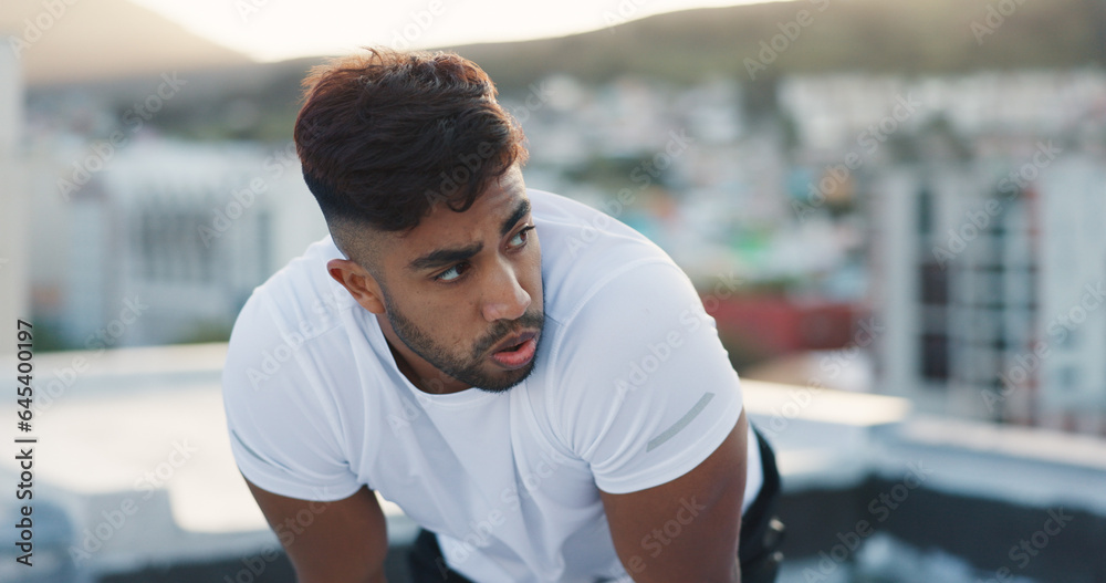 Fitness, city and tired man on a rooftop after running training, cardio workout and exercise outdoor