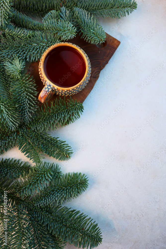 Ceramic cup with tea and fir branches. Concept of New Years card.Flat lay. Top view. Copy space.