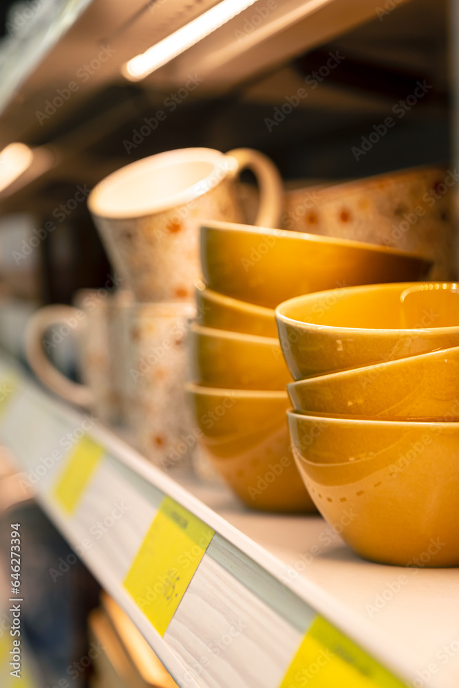 Variety of bowls and cups in modern household shop.