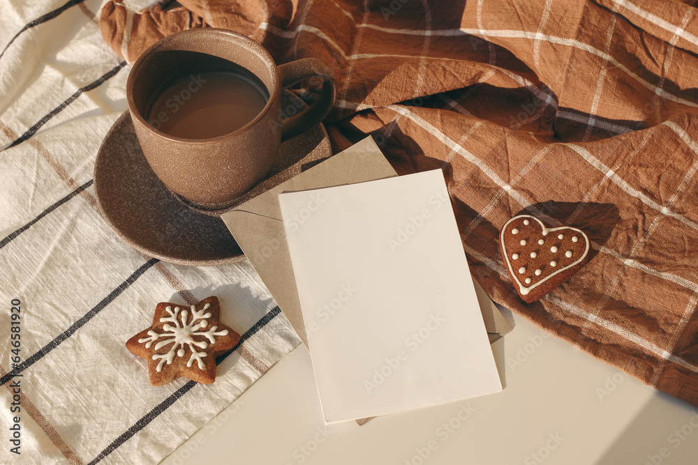 Winter festive still life. Cup of coffee, Star and heart shaped gingerbread cookies on checkered tab