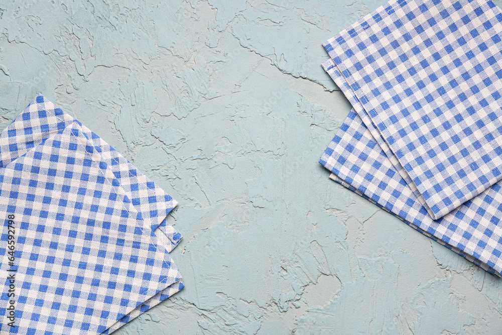 Set of clean folded napkins on color background