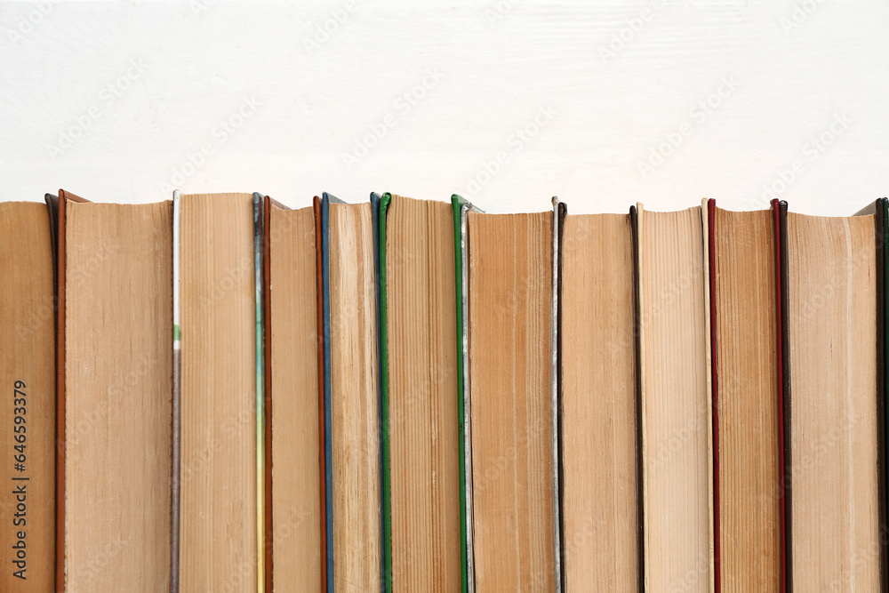 Row of books on white wooden background