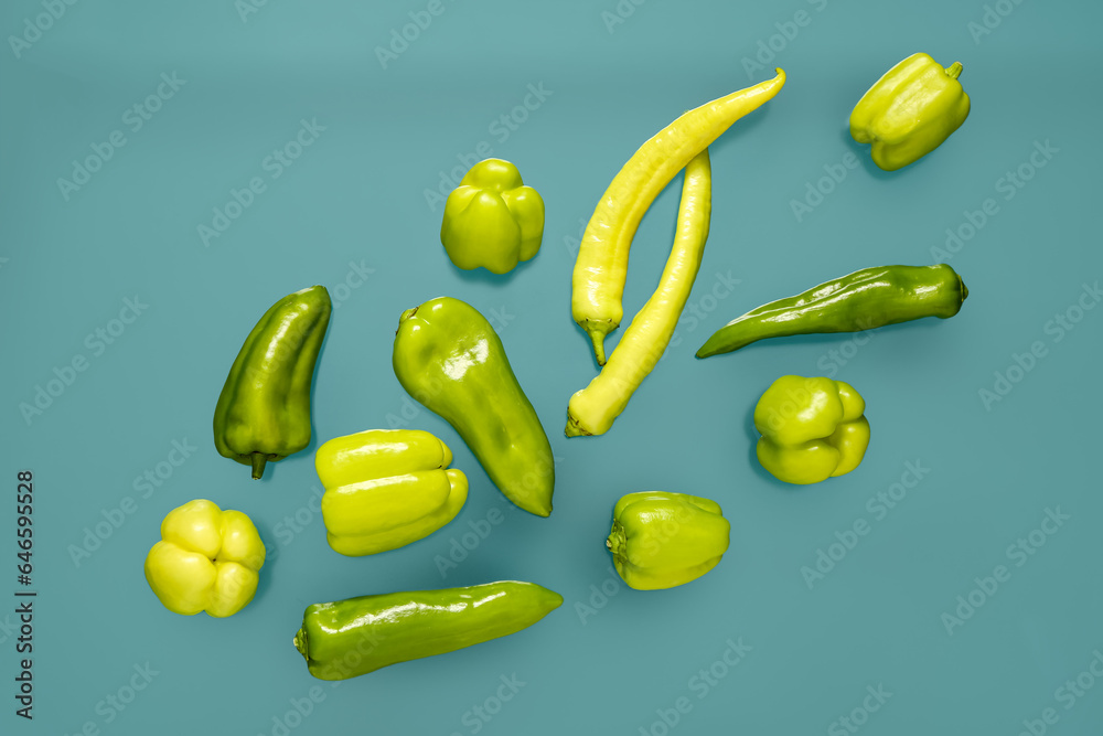 Different fresh peppers on blue background