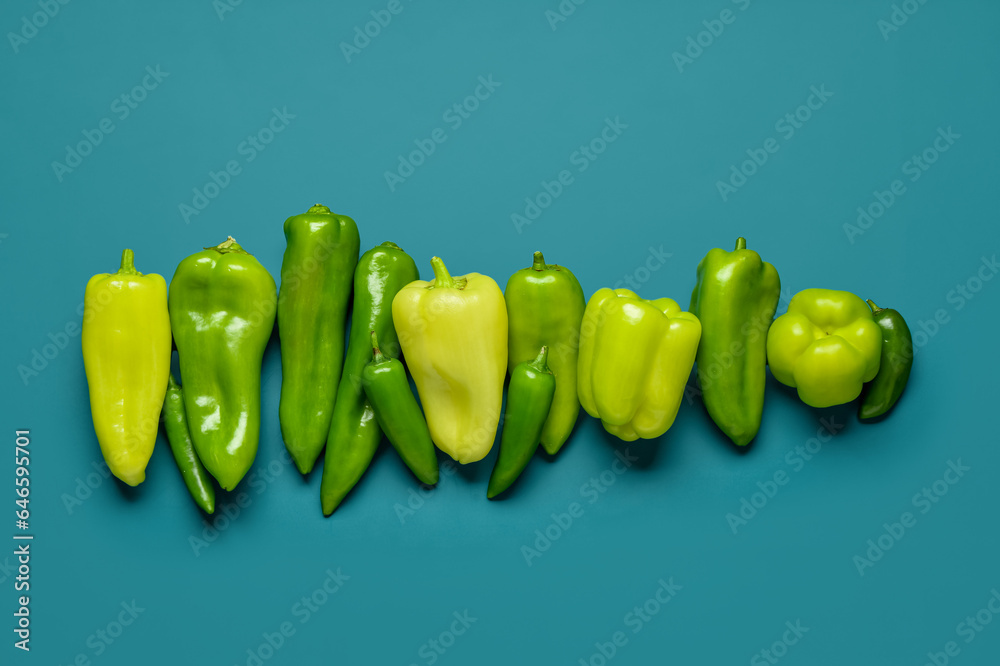 Different fresh peppers on blue background