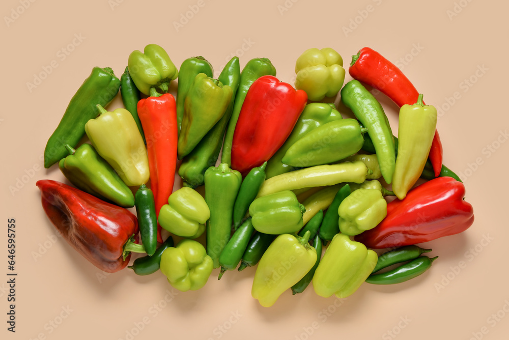 Different fresh peppers on beige background