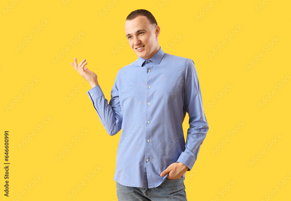 Young man on yellow background