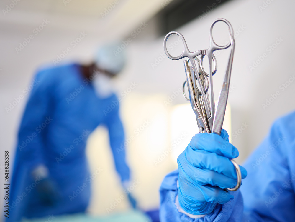 Hand, scissors and a doctor in a hospital or theatre to start operation with surgical tools. Zoom on