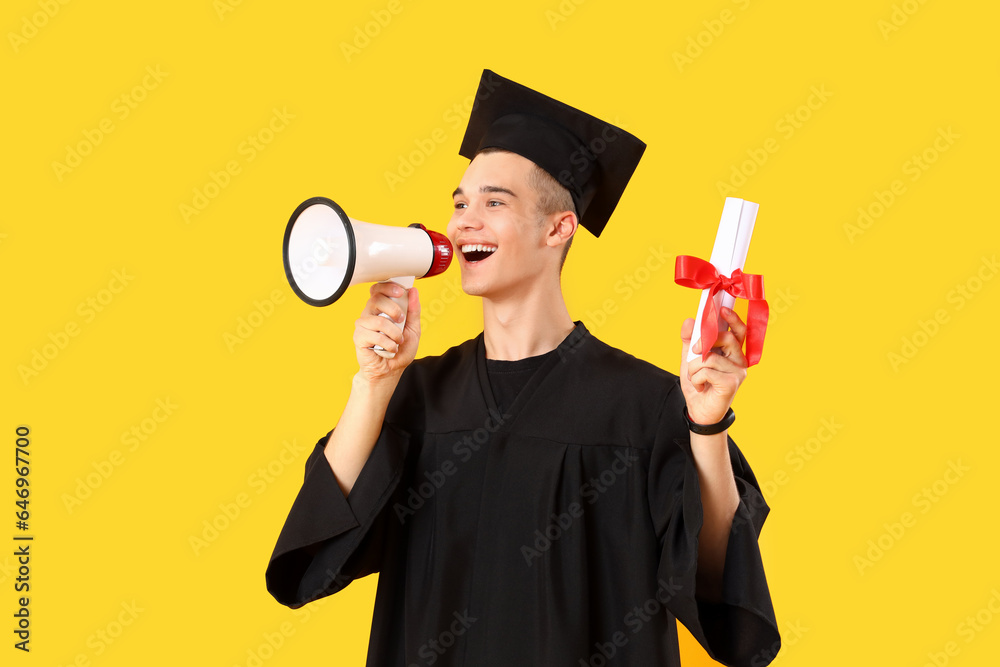 Male graduate student with diploma shouting into megaphone on yellow background