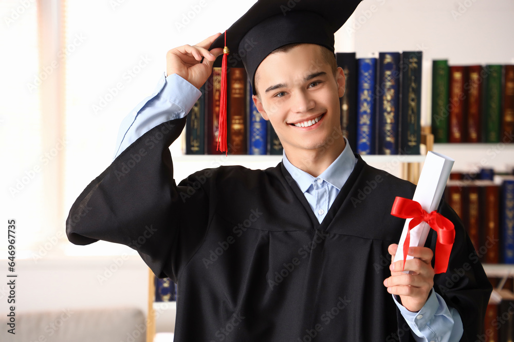 Male graduate student with diploma at university