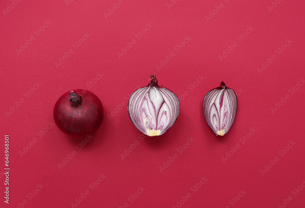 Fresh cut red onions on color background