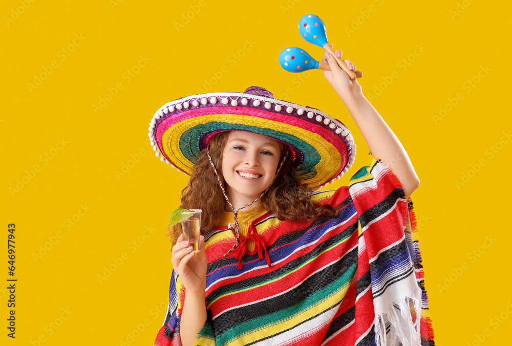 Happy Mexican woman with tequila and maracas on yellow background