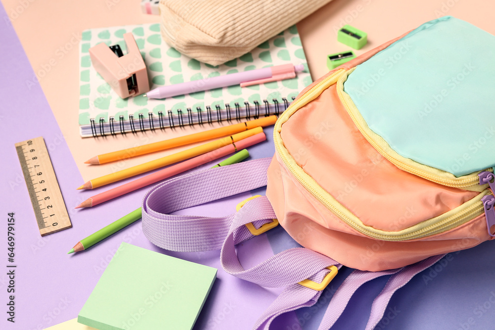 Stylish school backpack with different stationery supplies on colorful background