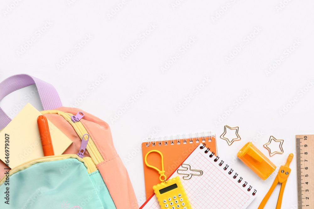 Stylish school backpack with different stationery supplies on white background