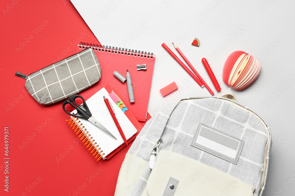 Stylish school backpack with different stationery supplies on colorful background