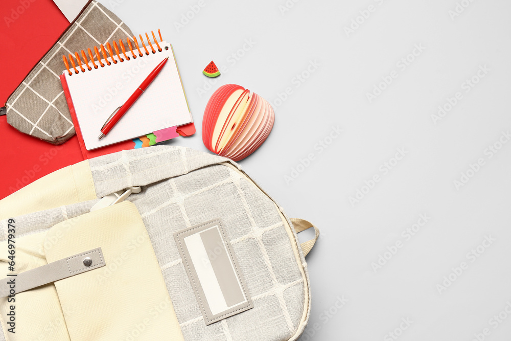 Stylish school backpack with different stationery supplies on colorful background