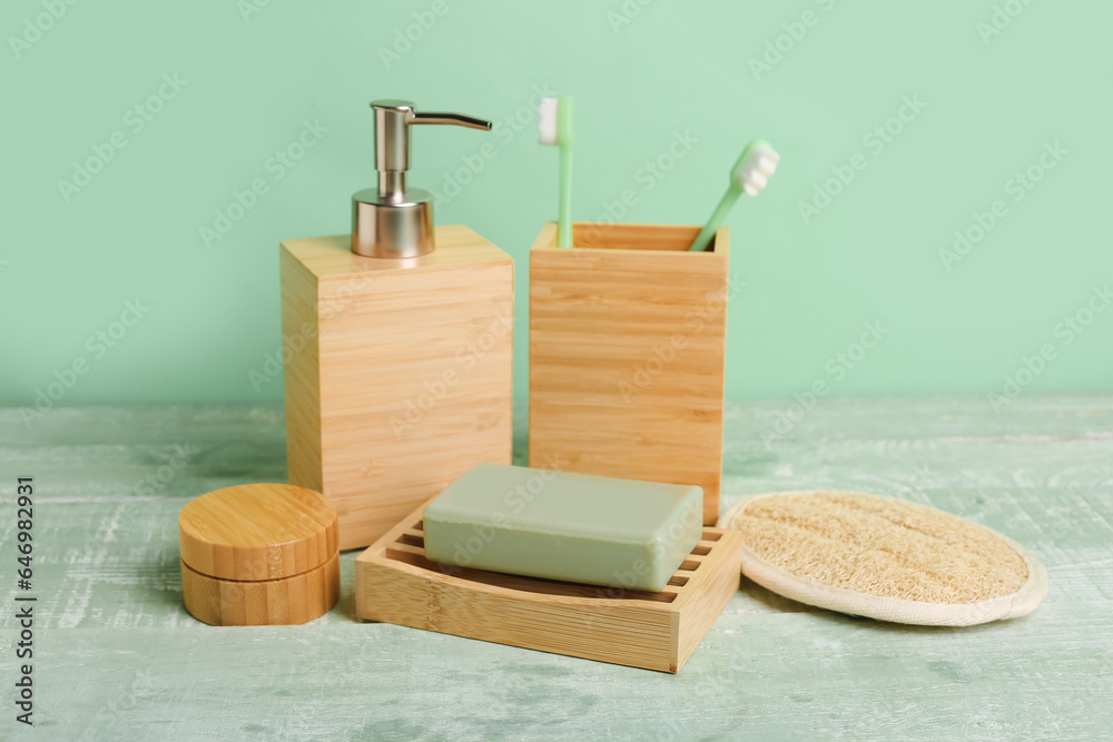 Set of bath supplies on color wooden table