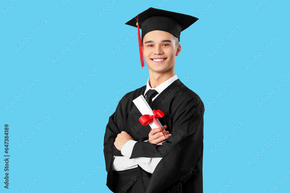 Male graduate student with diploma on blue background