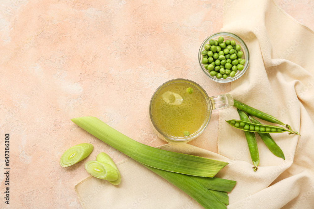 Glass cup of tasty vegetable broth on beige background