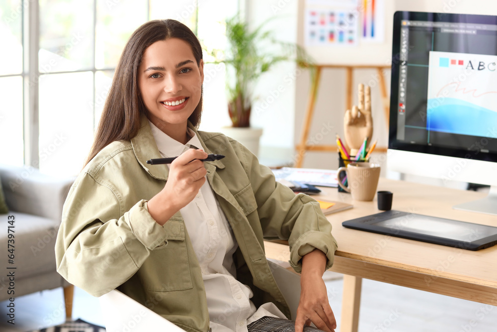 Female interior designer working at table in office