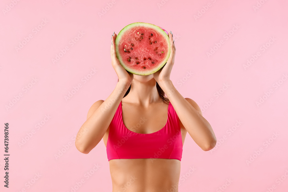 Young woman with fresh watermelon on pink background