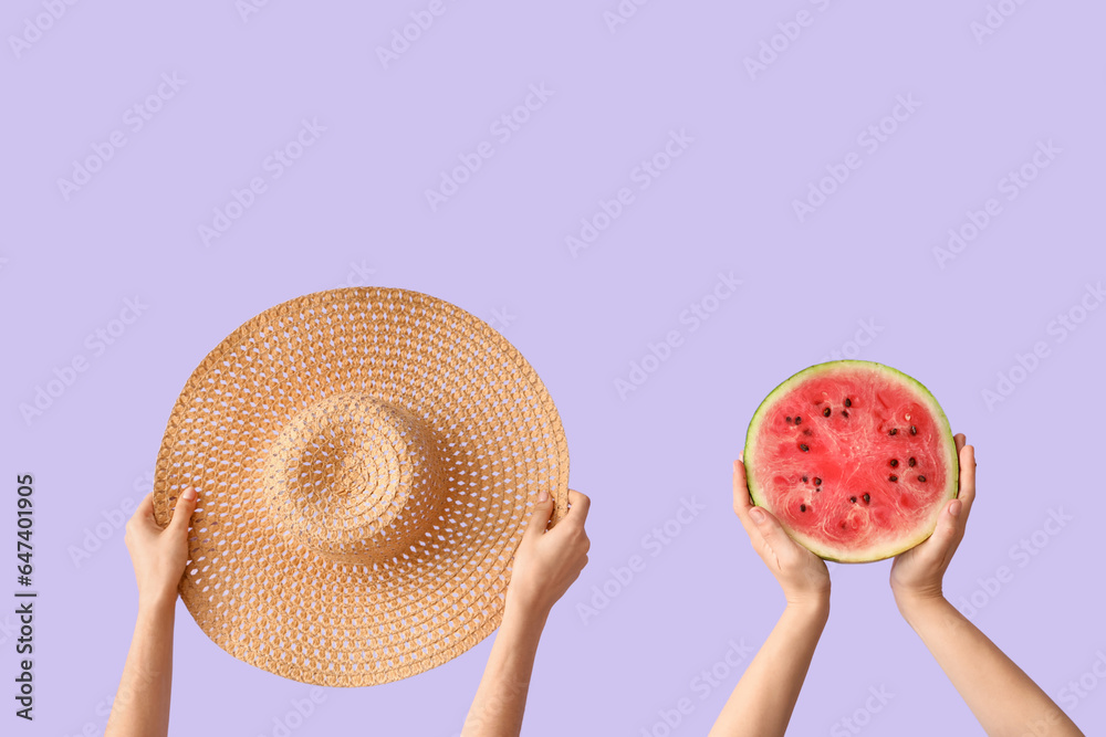 Female hands with slice of fresh watermelon and wicker hat on lilac background