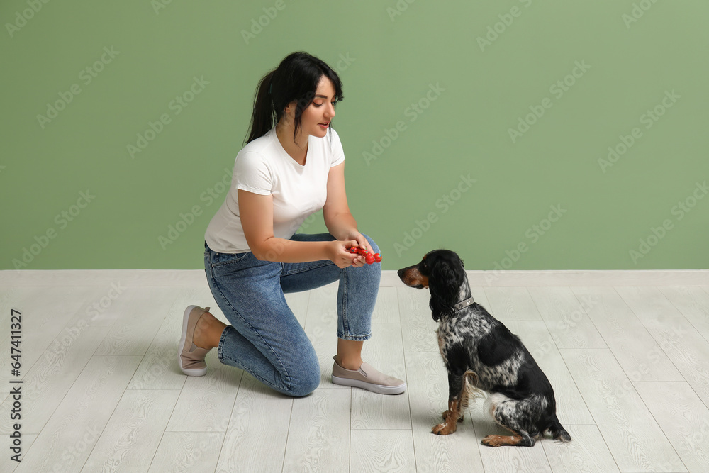 Female dog handler training pet at home