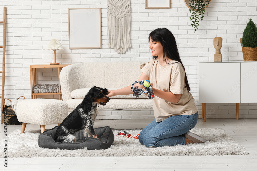 Woman playing with her dog at home