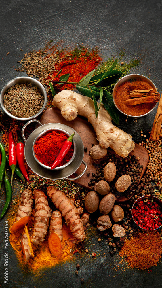 Spices on dark background. Different varius.