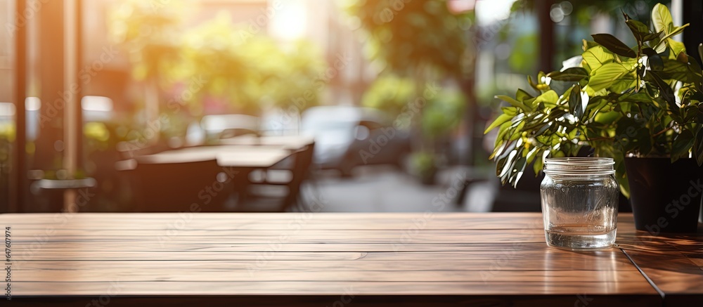 Bright daylight illuminates a modern cafe s blurred interior featuring a wooden table