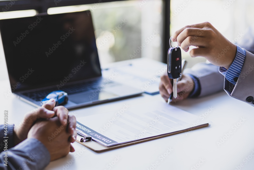 Businessman signing car purchase, lease contract agreement with car salesman, car insurance.