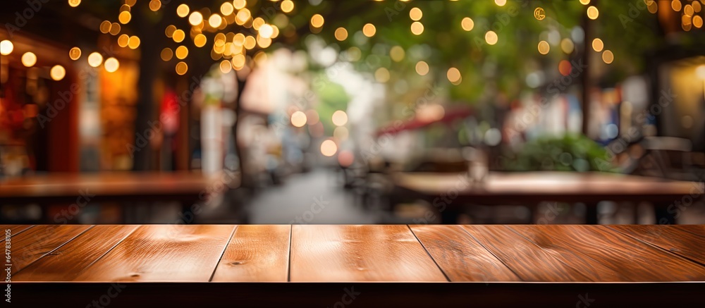 Product display on an empty brown wooden table in a coffee shop with a blurred bokeh background