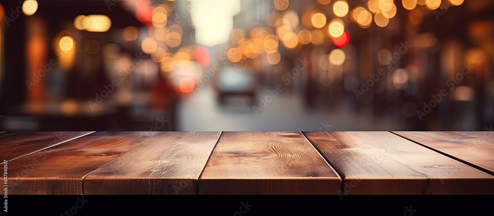 Empty brown wooden table and blurred background with bokeh image suitable for photomontage or produc