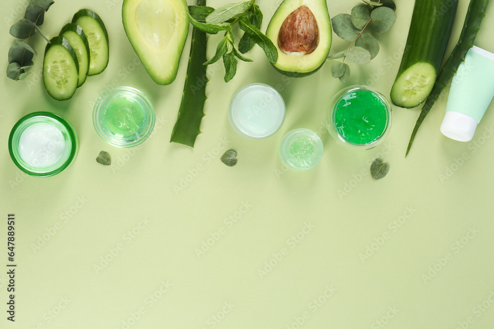 Flat lay composition with homemade cosmetic products and fresh ingredients on light green background