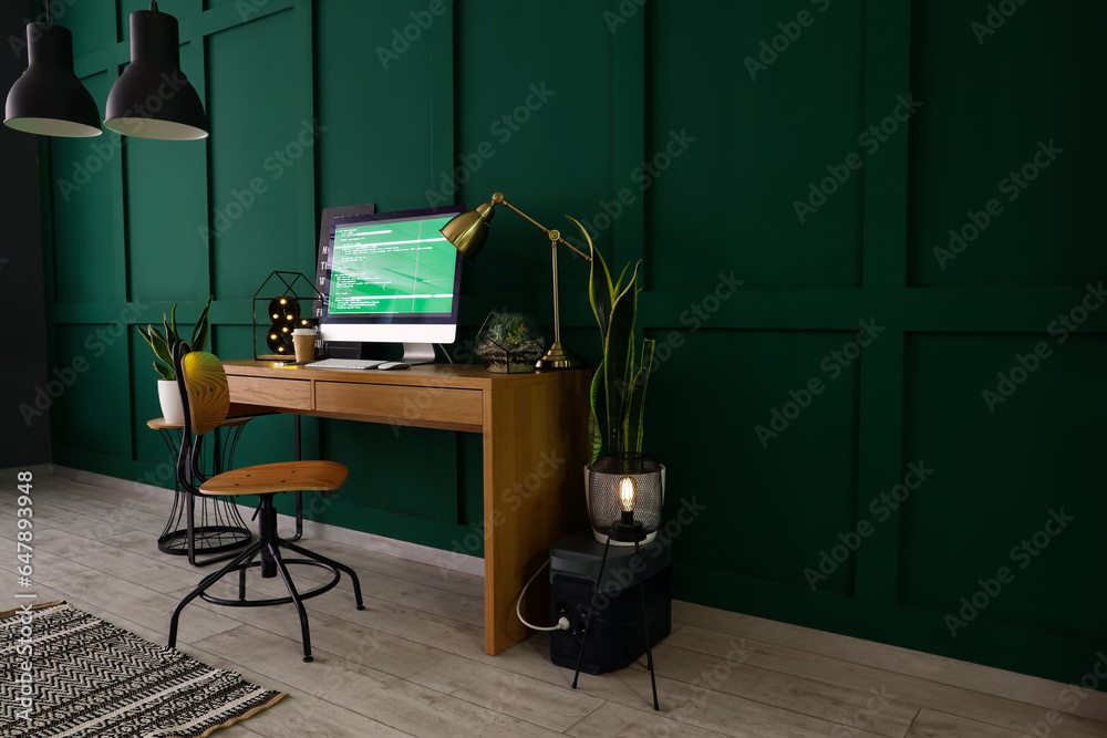 Interior of office with programmers workplace and houseplants