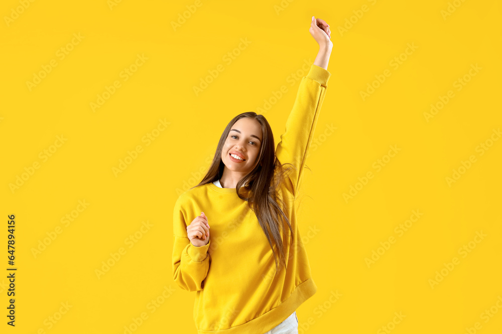 happy young woman on yellow background