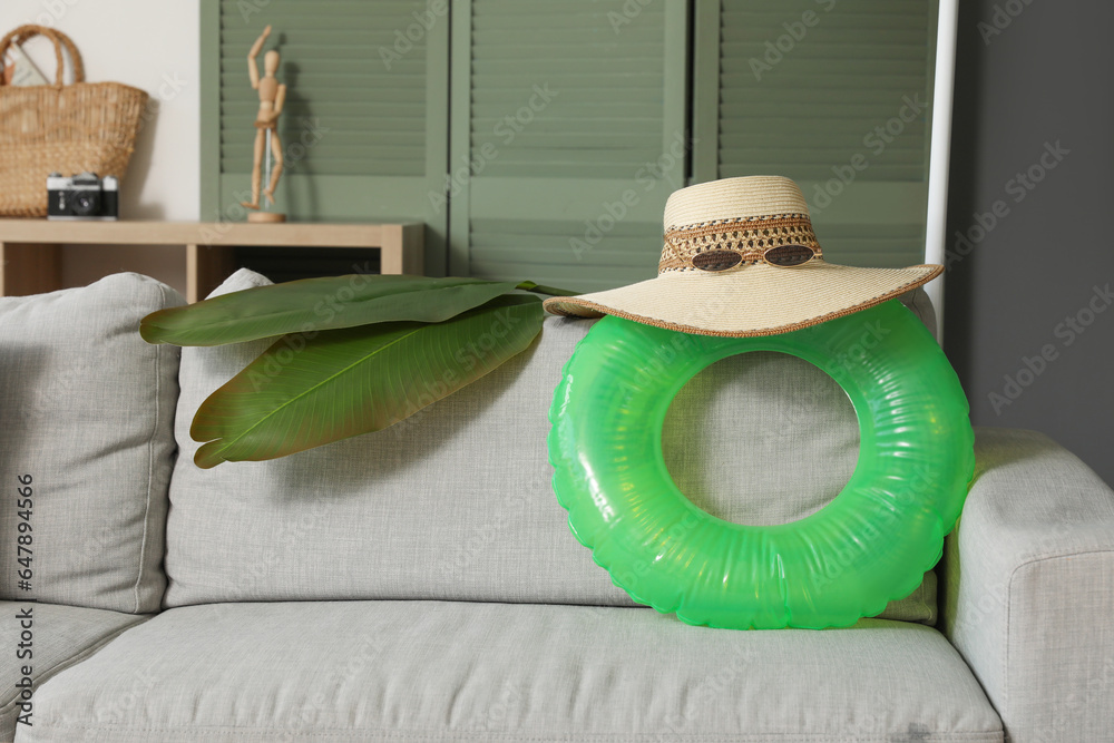 Interior of stylish modern living room with sofa and different beach accessories