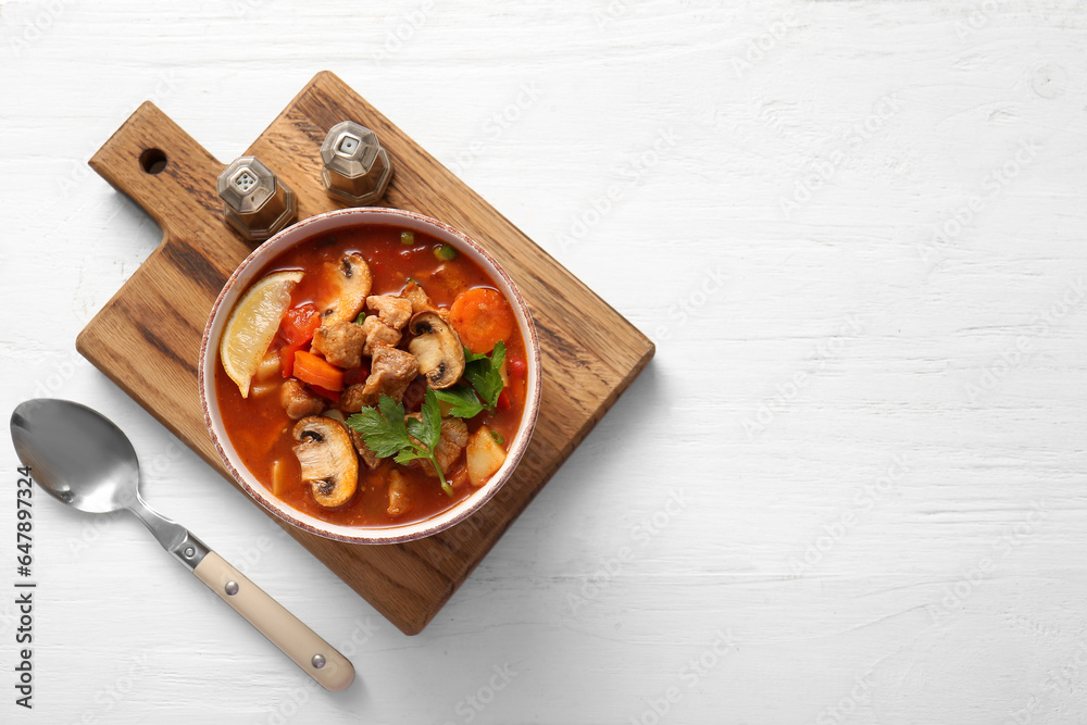 Bowl of tasty beef stew on white background