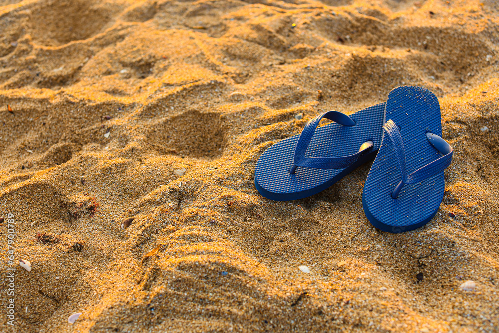 Stylish flips flops on sand at resort