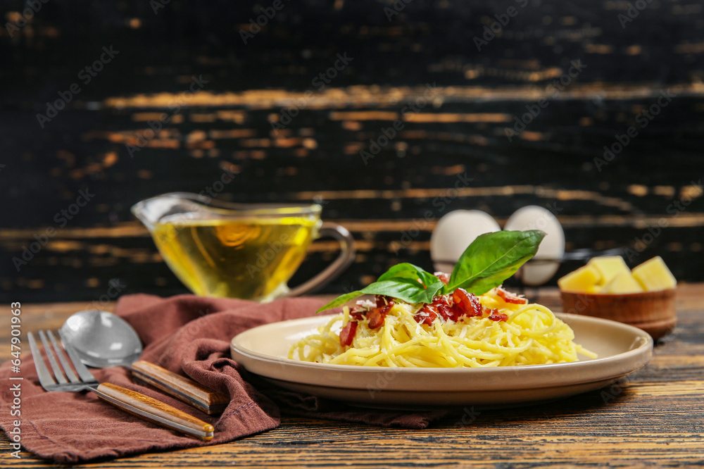 Plate with tasty pasta carbonara on table