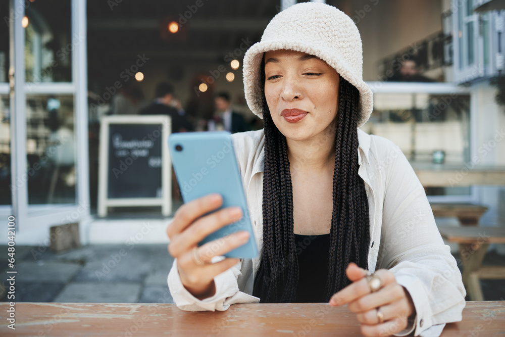 Student, travel and woman with phone at a cafe for social media, texting or chatting in a city. Smartphone, app and lady influencer at coffee shop for content creation, podcast or traveling blog post