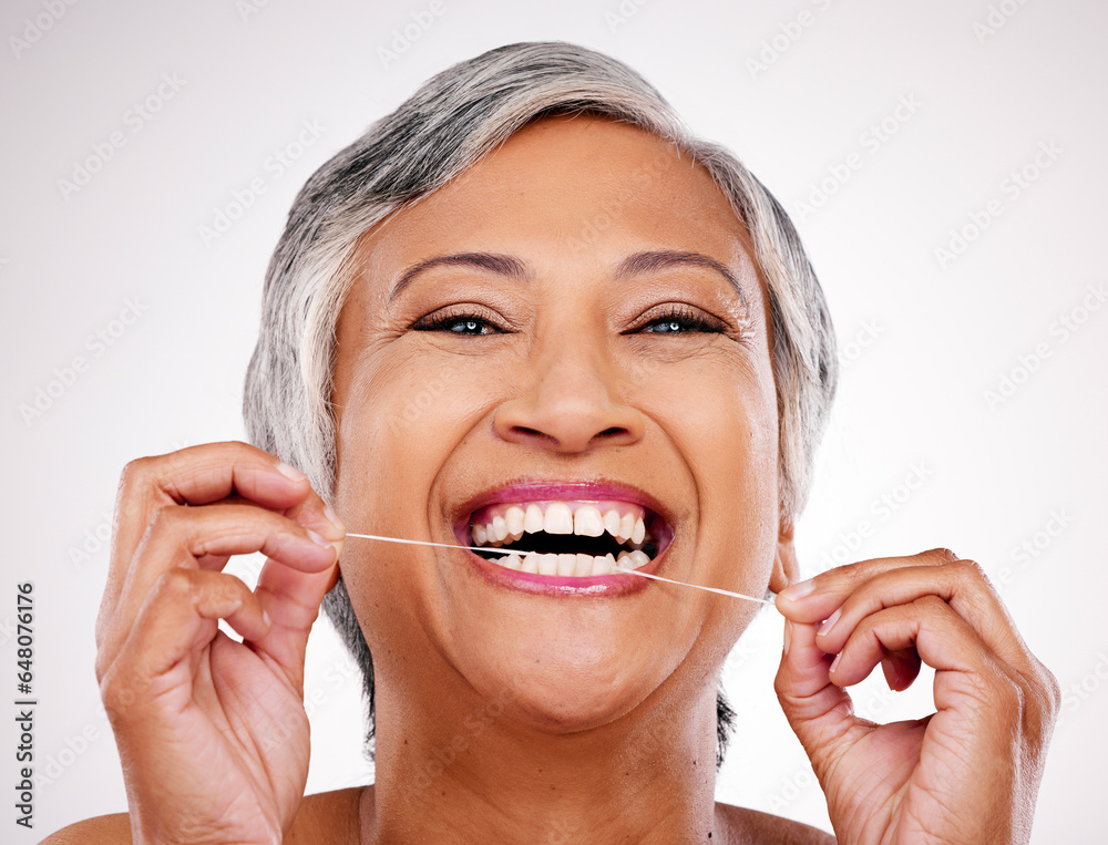 Senior woman, dental floss and studio portrait for healthcare, beauty and cleaning mouth by white background. Mature female model, teeth whitening and thread for self care, breath and healthy smile