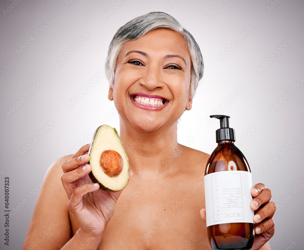 Mature woman, avocado and studio portrait for bottle, product and promo for nutrition by white background. Senior female model, fruit and excited for cleaning, beauty and skincare with organic oil