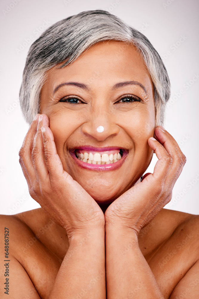 Senior, happy woman and portrait with face cream in skincare or beauty cosmetics against a studio background. Mature female person smile with lotion, creme or moisturizer for spa or facial treatment