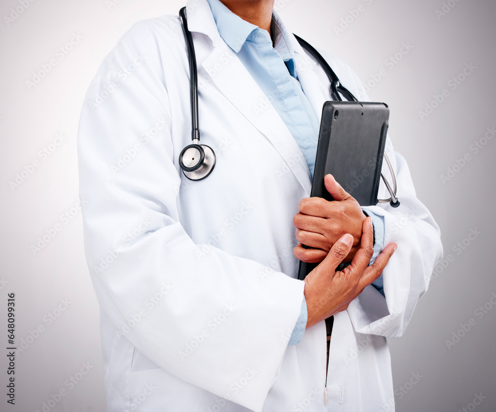 Doctor, technology and hands with tablet in studio for healthcare services, telehealth support and help. Closeup of professional medical worker, digital connection and consulting on grey background