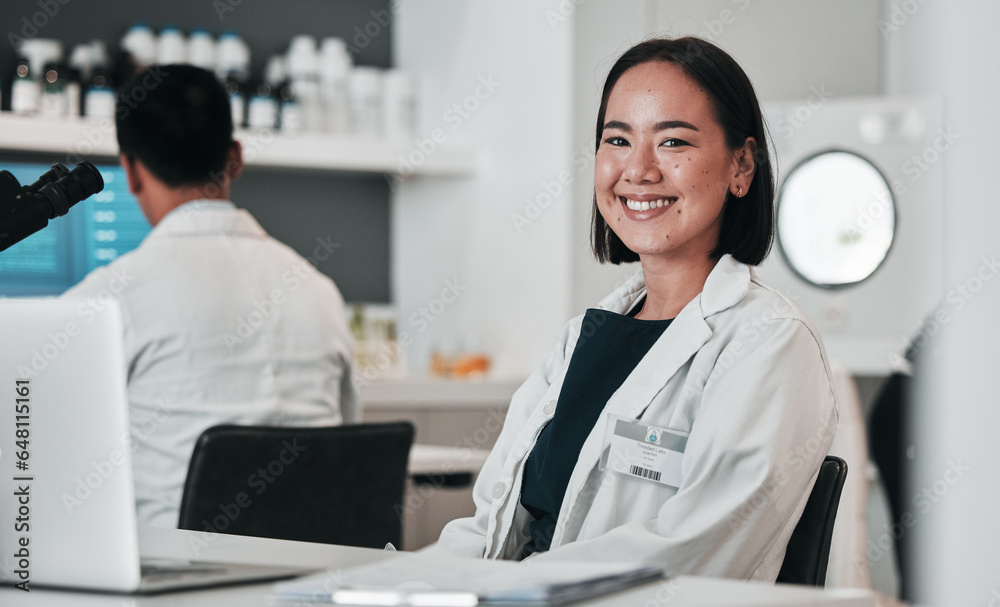 Scientist, woman and portrait at laptop in laboratory for innovation, research and biotechnology software. Happy asian science technician working online to review data, investigation and development